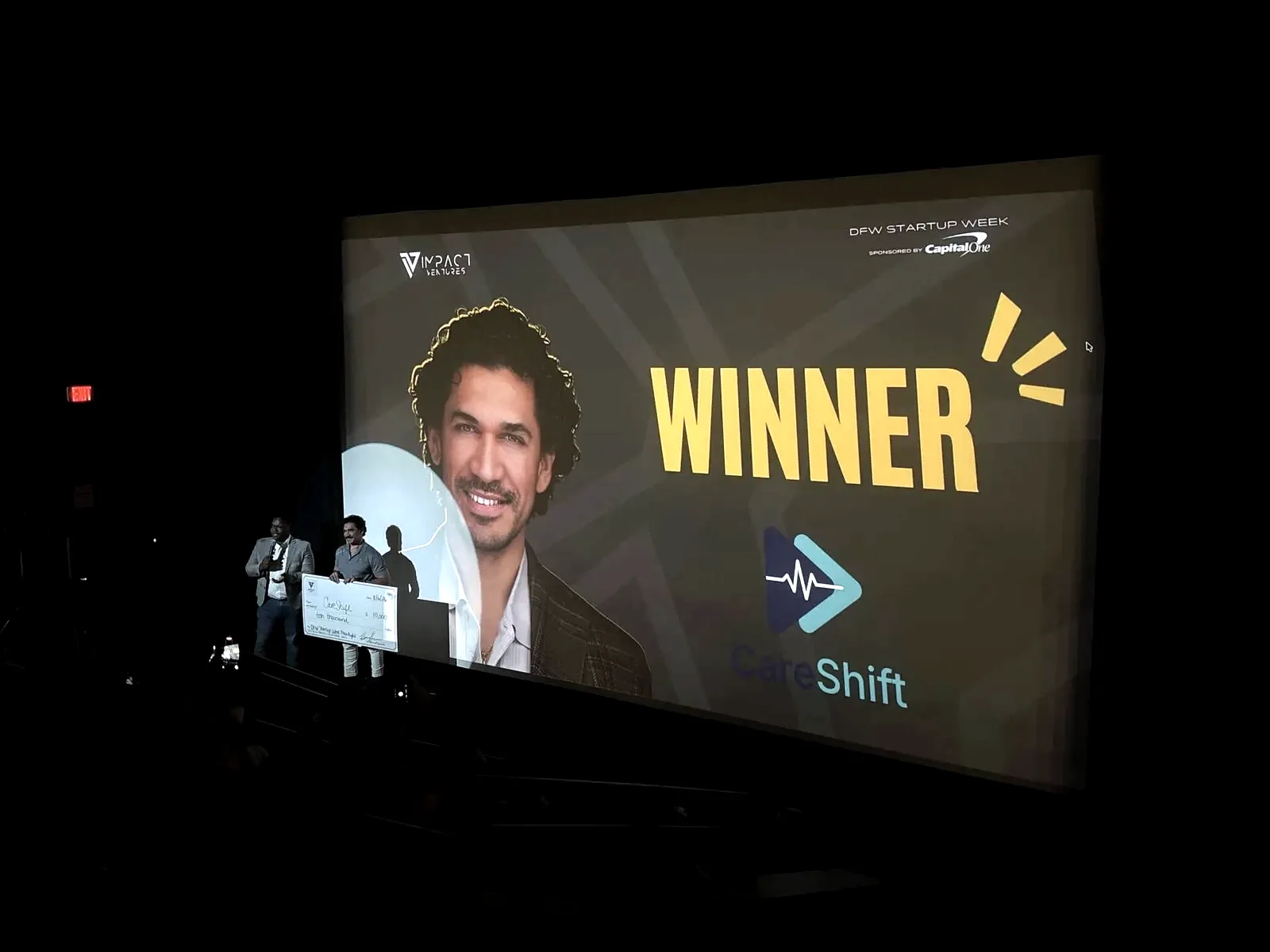 The CareShift founder on stage receiving the DFW Startup Week pitch competition award at the Texas Theatre